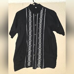 Guayabera shirt with white embroidery.